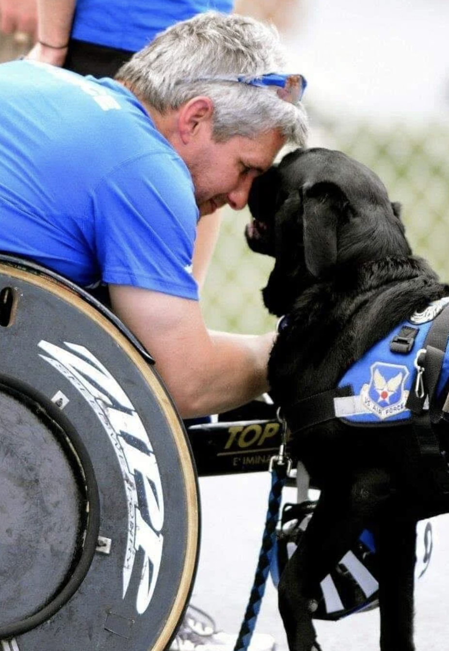 Jason Morgan forehead-to-forehead with his service dog Yago